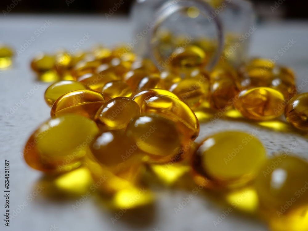 layout of yellow gelatin capsules filled with fish oil-omega 3