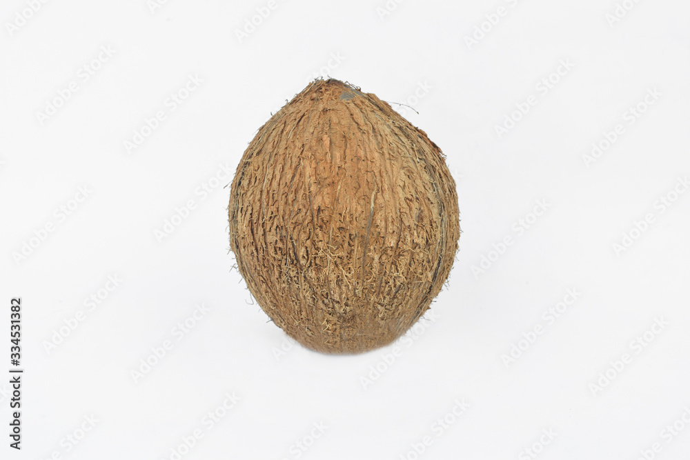 Portrait of a fresh coconut in the middle of an isolated white background Portrait of a fresh coconut in the middle of an isolated white background