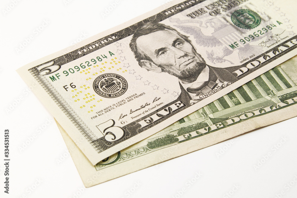 Five dollar bills in cash on white background Five dollar bills in cash on white background
