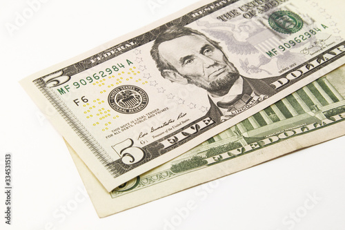 Five dollar bills in cash on white background