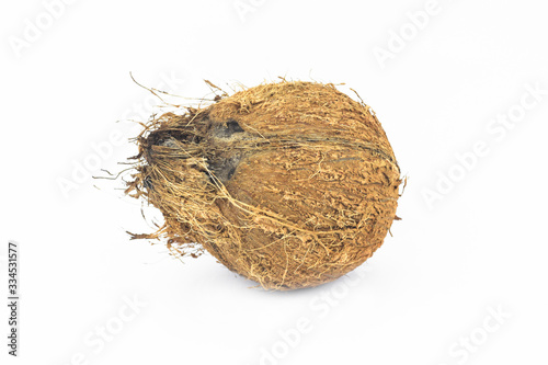 Portrait of a rustic coconut in the middle of an isolated white background
