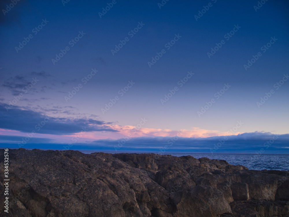 Sunset rocks and a light sky with gentle lights