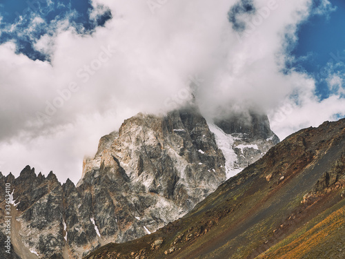 View of Ushba mountain covered by cloud in Svaneti region of Georgia, close up