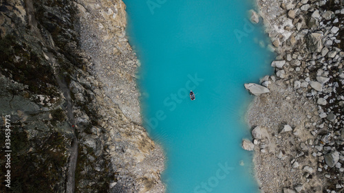Aerial top view on turquoise water lake surrounded by rocks and sand in Huaraz, National Park, Peru - highest mountainous range in South America. 