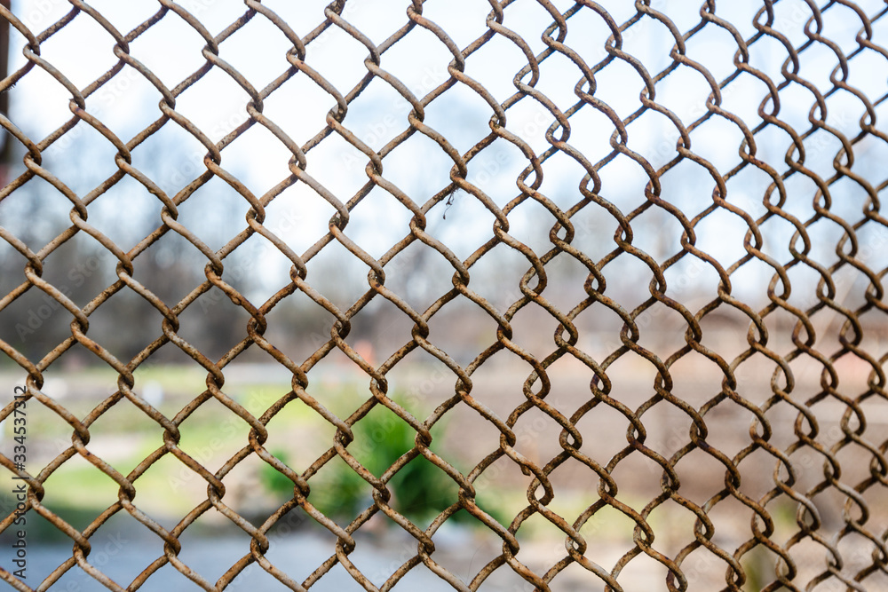 Fototapeta premium detail of a piece of fence or flexible metal lattice on the outside
