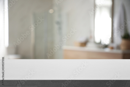Empty table and blurred view of stylish bathroom interior