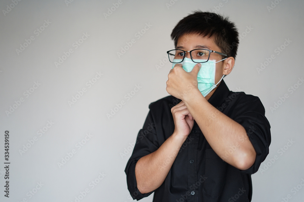 The man wearing face hygienic mask for prevention global covid-19 virus pandemic. Lift his hand stop and full the mask on face.He have fever illness, cough, sneeze. Covid19 made people death. The man wearing face hygienic mask for prevention global covid-19 virus pandemic. Lift his hand stop and full the mask on face.He have fever illness, cough, sneeze. Covid19 made people death.