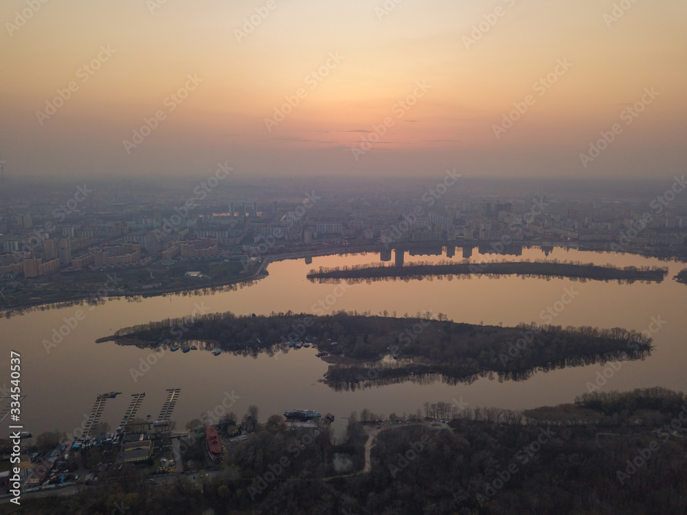 Fototapeta premium Sunset over the Dnieper River in Kiev. Aerial drone view.