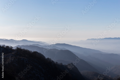 mountain landscape, on the horizon you can see the silhouettes of the mountains with different shades of blue