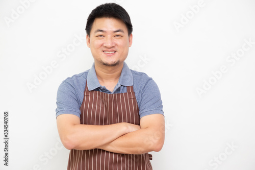 Portrait of Asian workers fresh market with brown apron standing with arms crossed isolated on white background