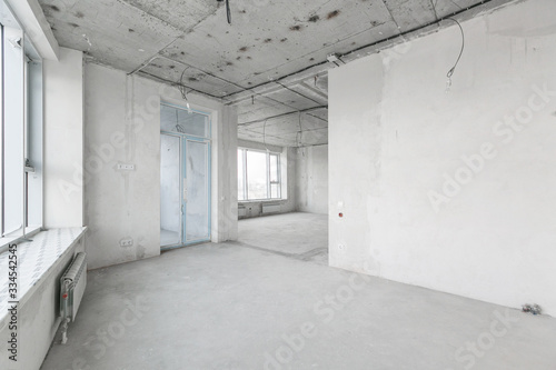 interior of a new apartment without finishing in gray tones with electrical wiring