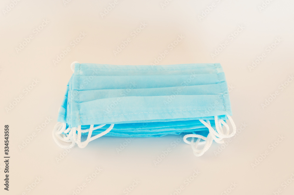 Fototapeta premium Protective medical masks are stacked on the table. Preparation for the departure for patients covid-19. Humanitarian Aid: A concept of protection during a coronavirus pandemic.