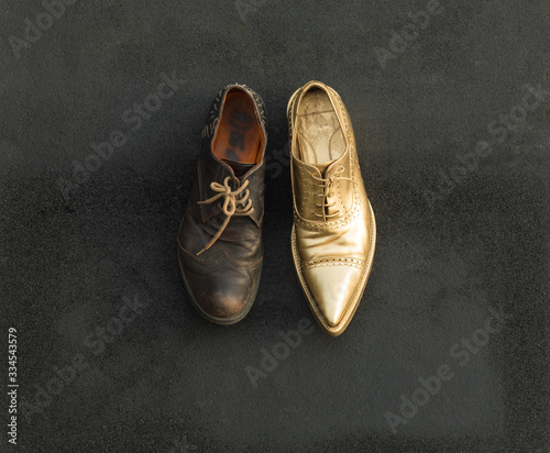 concept of rich and poor in a shoes, old and golden shoe photo