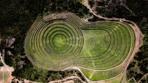 Fotografiet Aerial view of Moray Archeological site - Inca ruins of several terraced circular depressions, in Maras, Cusco province, Peru