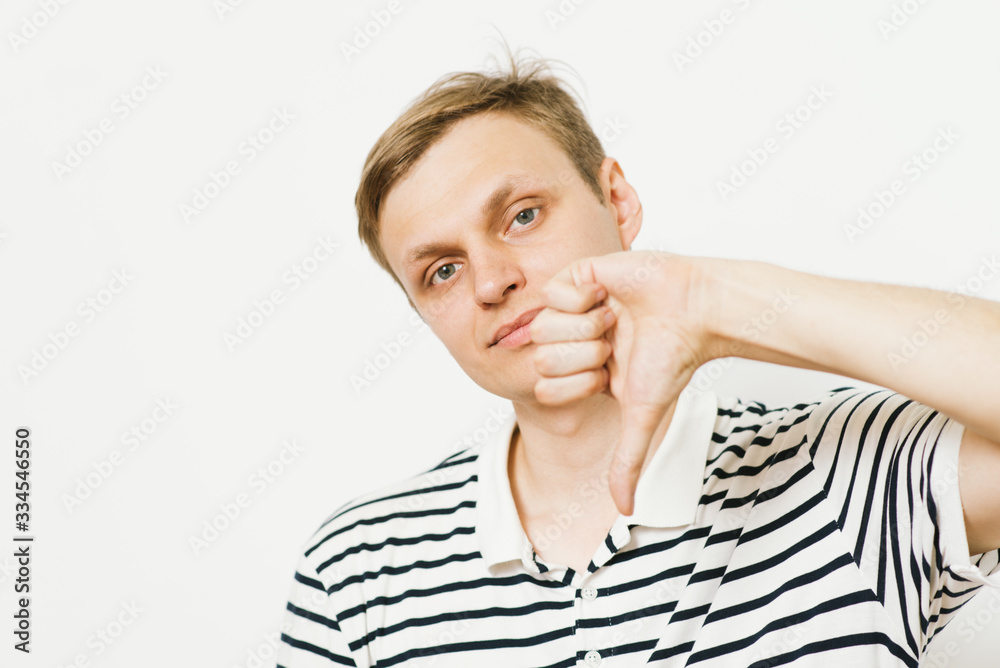 man showing a thumb down gesture man showing a thumb down gesture