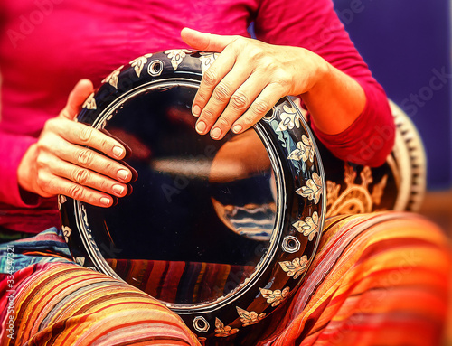 Woman drummer with her drum, Ornamental darbuka and painting effect. photo