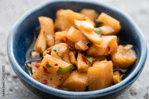 close up of tasty daikon radish kimchi in bowl