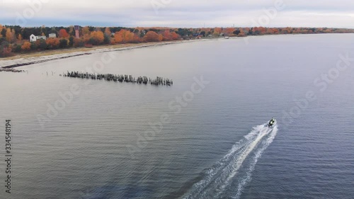 Boat driving along wooden jetty