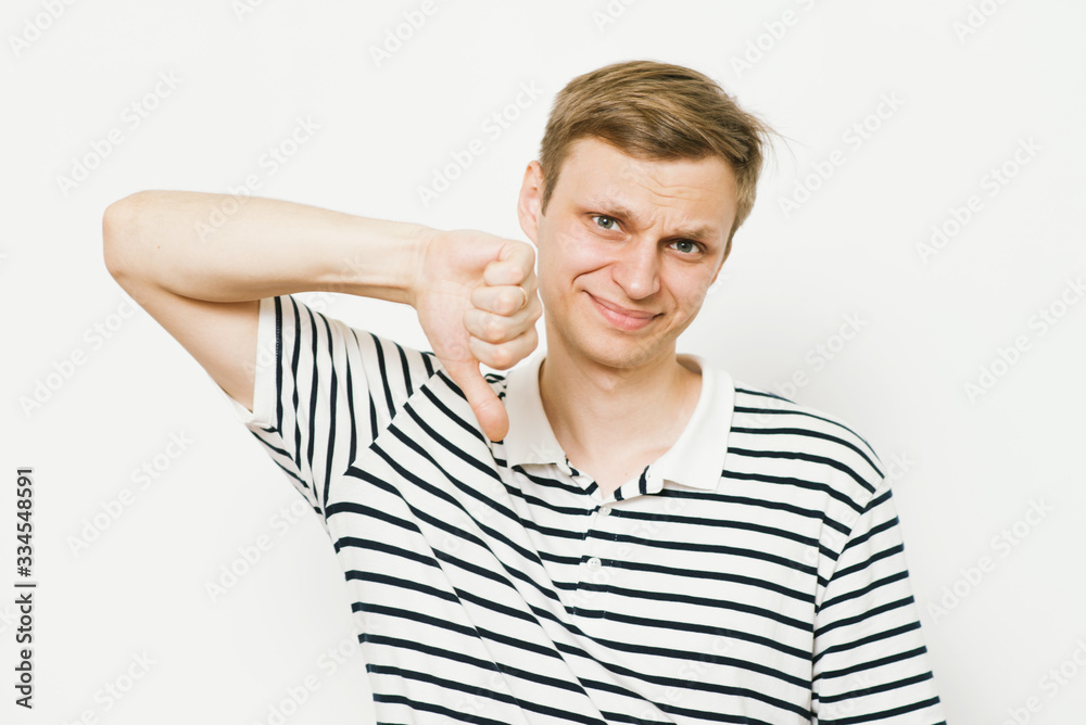 man showing a thumb down gesture man showing a thumb down gesture