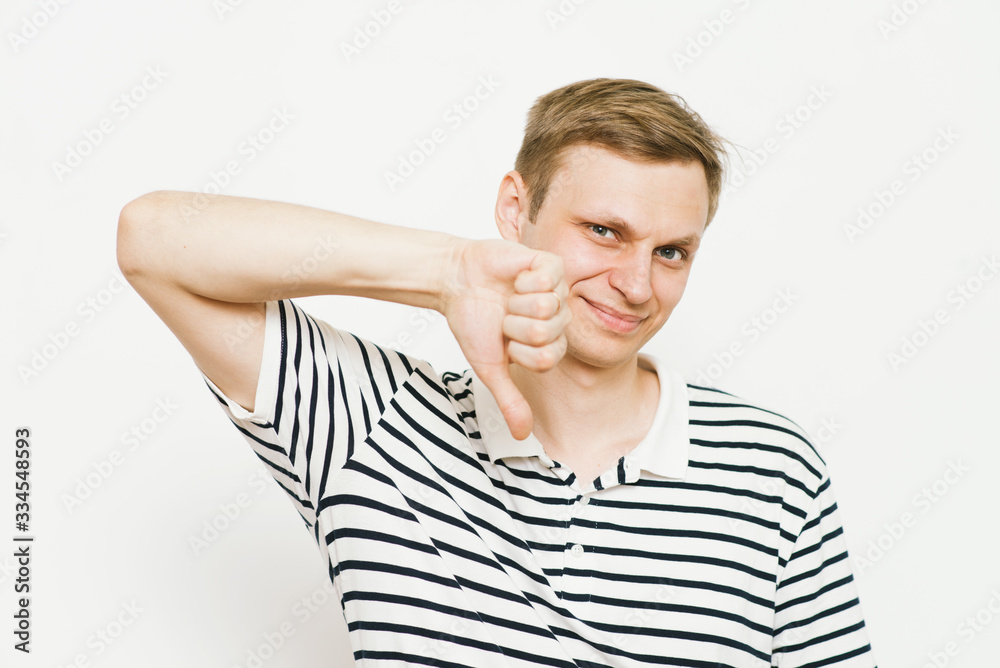 man showing a thumb down gesture man showing a thumb down gesture