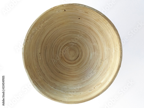 Aerial view of round natural wood bowl isolated on white background. Close up Handmade kitchen crafts, environmentally friendly.