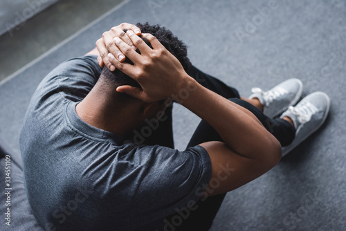 depressed african american man having panic attack at home
