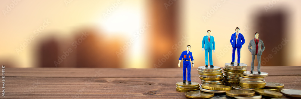 Miniature people: businessmenstanding on stack of coins with some coins, city backround. Thay are rich. Money, Financial, Business Growth concept.
