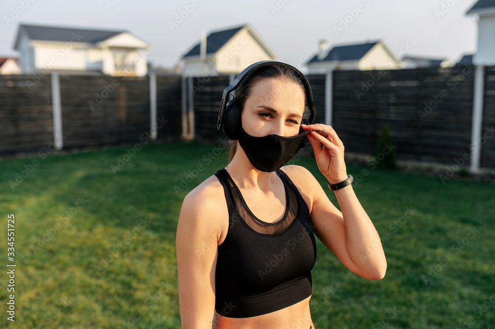 Attractive sporty style woman in a medical mask