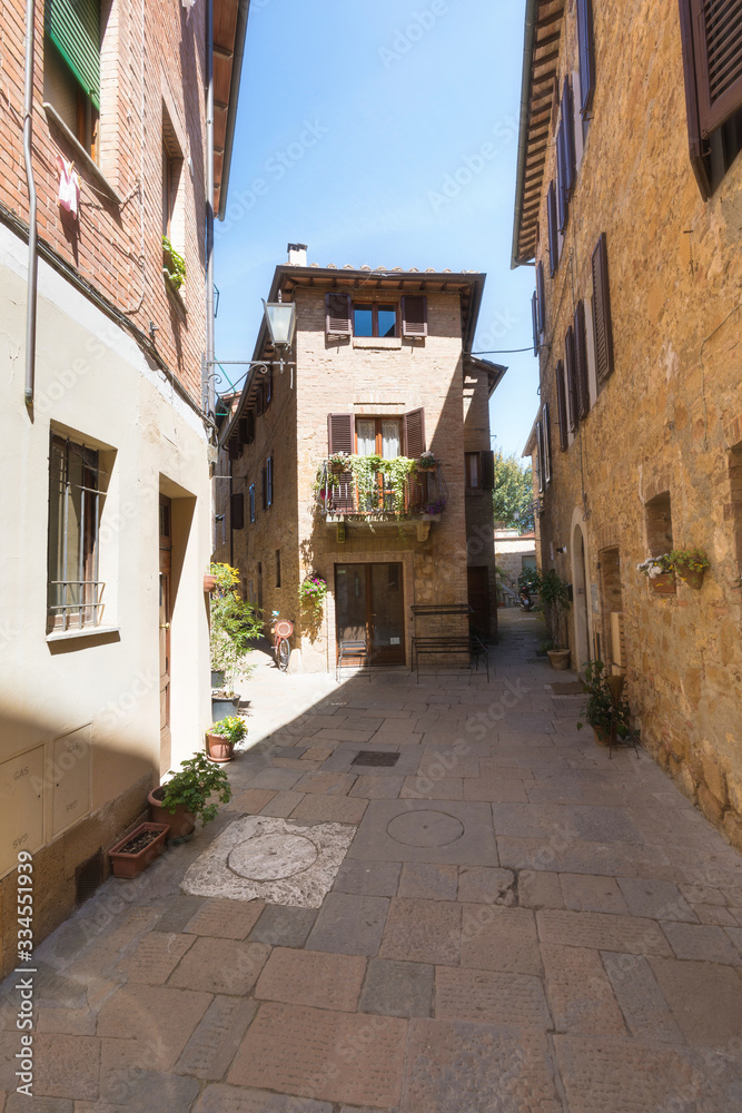 Beautiful Italian street during summer or spring season of a small old provincial town. Picturesque corner of a quaint hill town Tuscany Italy. Coronavirus impact, empty street. Travel background