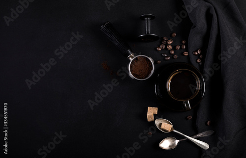 Coffee and utensils for coffee maker on black background with copy space for text