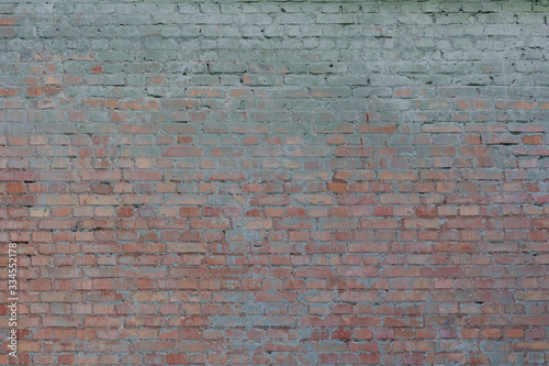 Old vintage dirty brick wall with peeling plaster. Background and texture