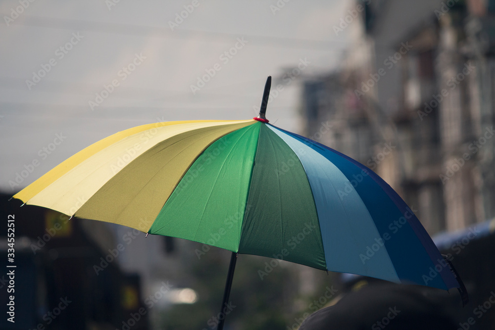 Rainbow flag umbrella at pride parade. Lgbt