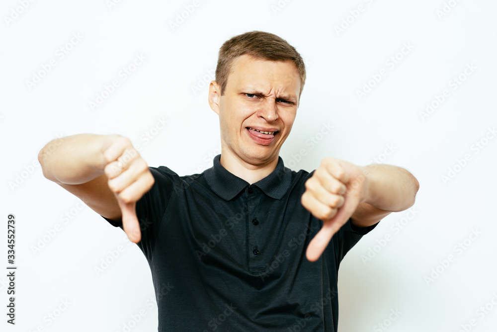 man showing a thumb down gesture man showing a thumb down gesture
