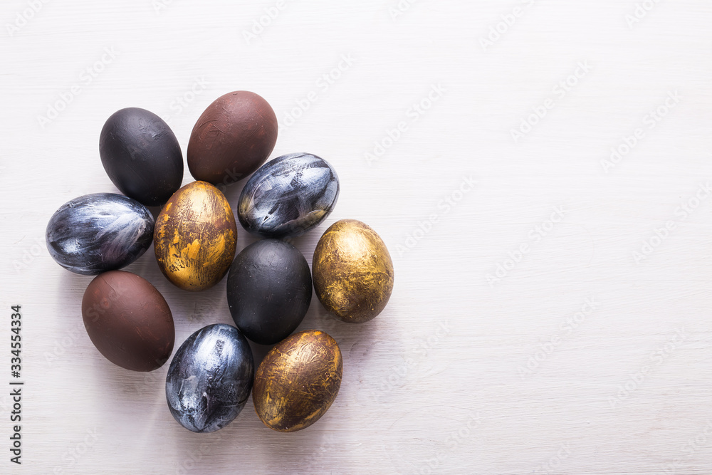 Holidays, traditions and Easter concept - Dark stylish easter eggs on white wooden background with copyspace. Holidays, traditions and Easter concept - Dark stylish easter eggs on white wooden background with copyspace.