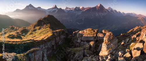 Summer holiday season. Sunrise view on Bernese range above Bachalpsee lake. Highest peaks Eiger, Jungfrau and Schreckhorn in famous location. Switzerland alps, Grindelwald valley. Travel background