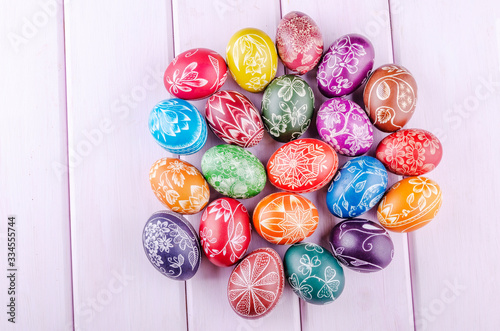 Canvas Print Variety of colorful handmade scratched easter eggs on wooden table