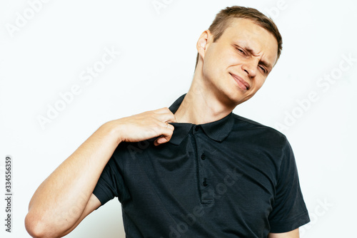 Closeup portrait of young man opening shirt to vent,it's hot. Negative emotion, facial expression, feeling