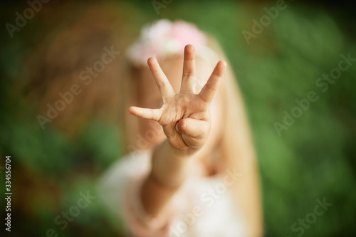 girl shows 4 fingers photo