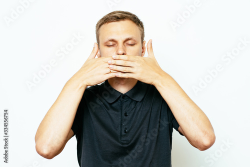 man closes a mouth hands