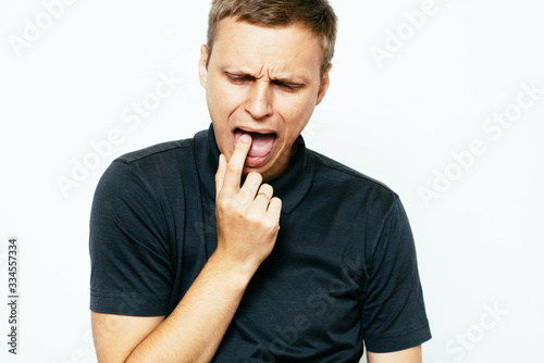 male of European appearance causes vomiting putting his fingers in his mouth on a , nausea