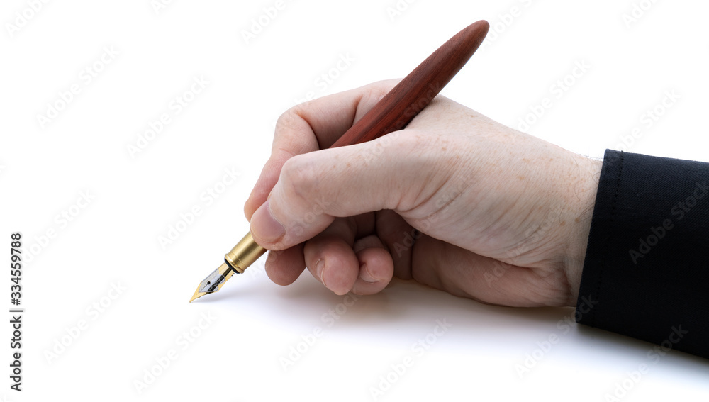 Holding fountain pen in hand front view with black shirt on white background with narrow focus Holding fountain pen in hand front view with black shirt on white background with narrow focus