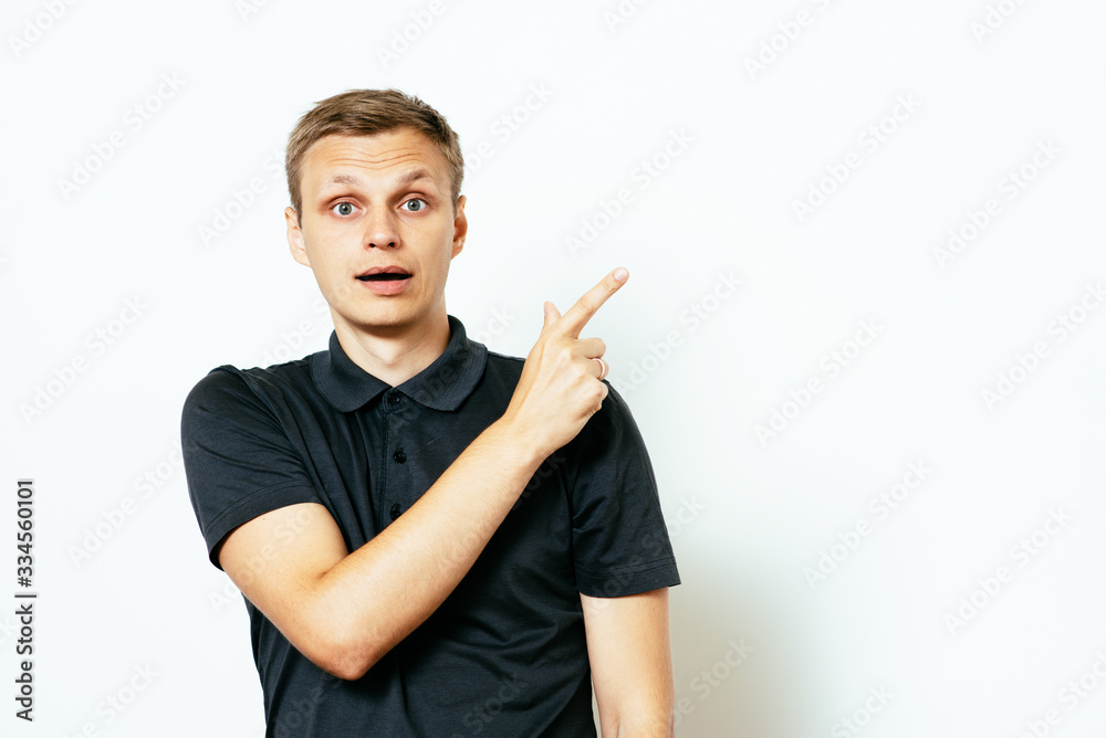 young man, pointing with finger at someone or something. Positive human face expressions, emotions, feelings, attitude, approach young man, pointing with finger at someone or something. Positive human face expressions, emotions, feelings, attitude, approach