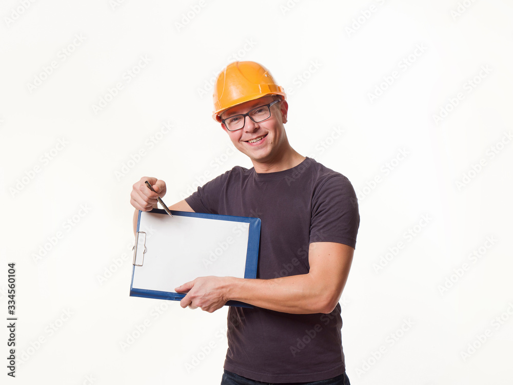 young man - worker in a helmet with a folder young man - worker in a helmet with a folder