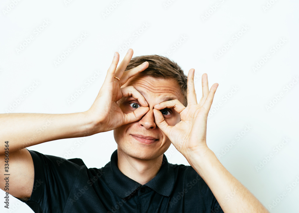 man looking through hands, making binoculars man looking through hands, making binoculars