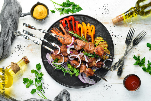 Grilled veal skewers and grilled vegetables. Top view. Barbecue. photo