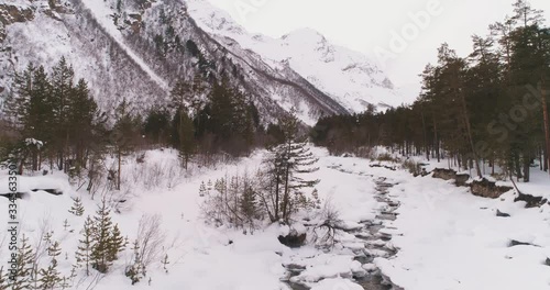 River in a snowy mountain forest. 