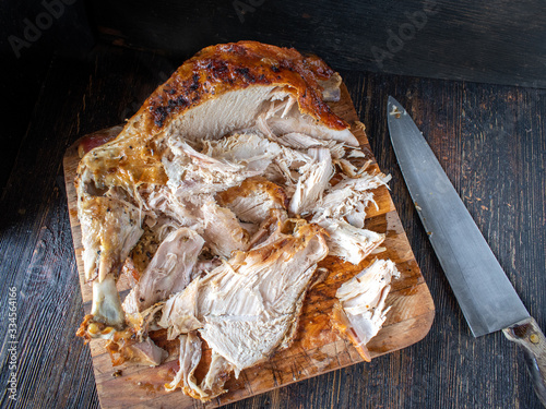 sliced baked golden brown turkey meat on cutting board photo