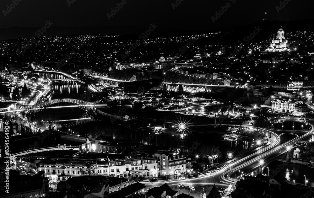 Panoramic night view from Narikala fortress down to city center streets and bridges, Capital of Georgia - Tbilisi. Romantic Sakartvelo. 2020