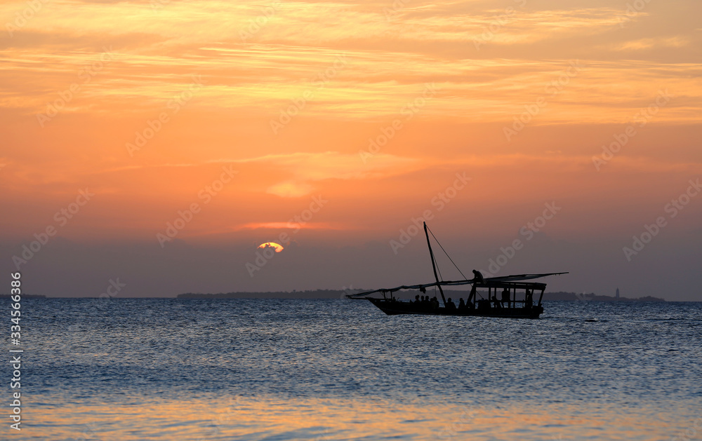 boat in ocean on sunset background