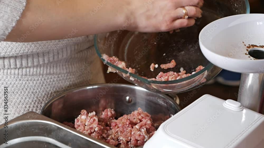 The girl is cooking minced meat. The girl transfers the prepared minced meat from a bowl to the pan. Meat dishes The girl is cooking minced meat. The girl transfers the prepared minced meat from a bowl to the pan. Meat dishes